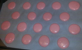 Pipe circles of the macaron batter onto a baking sheet lined with parchment paper.